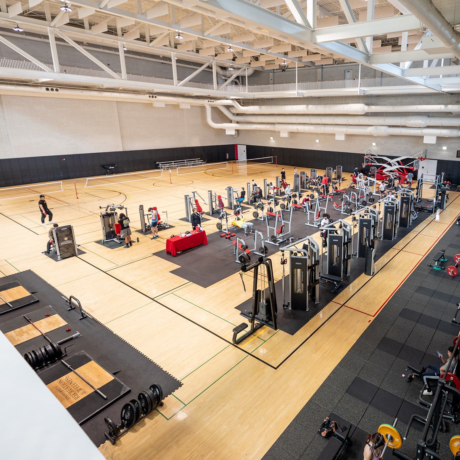 Large open gymnasium with a lot of exercise equipment